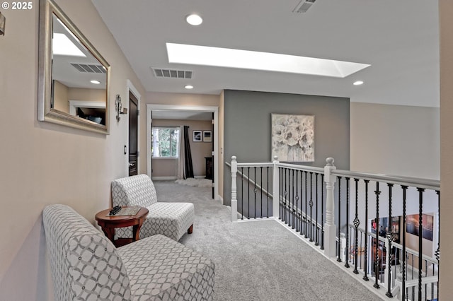 corridor featuring a skylight and carpet