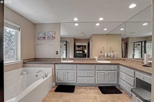 1044 N 26th Ter, Cornelius, OR 97113 - bathroom featuring double vanity, a garden tub, recessed lighting, and a shower with shower door