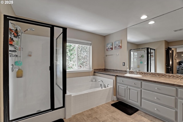 1044 N 26th Ter, Cornelius, OR 97113 - bathroom with a shower stall, a bath, vanity, and recessed lighting