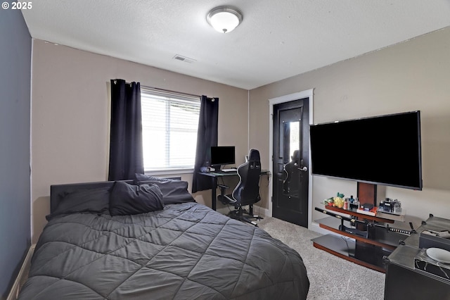 carpeted bedroom featuring a textured ceiling