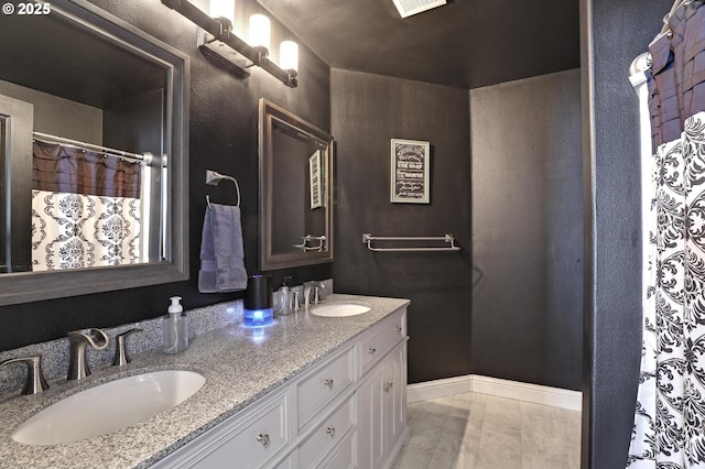 1044 N 26th Ter, Cornelius, OR 97113 - bathroom featuring double vanity, baseboards, and a textured wall