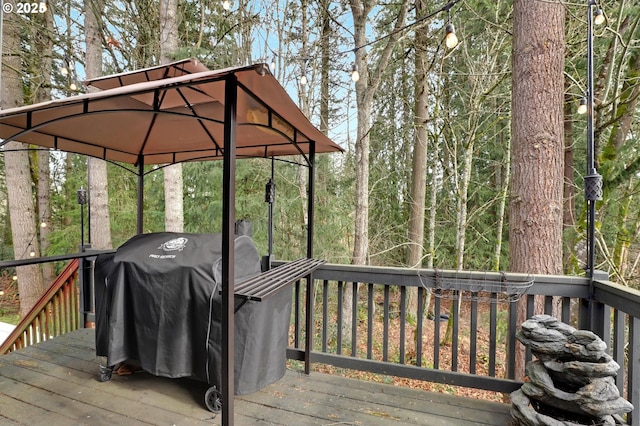 wooden deck with a grill and a gazebo