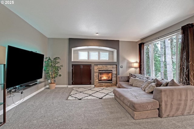 carpeted living room with a healthy amount of sunlight, a fireplace, and a textured ceiling