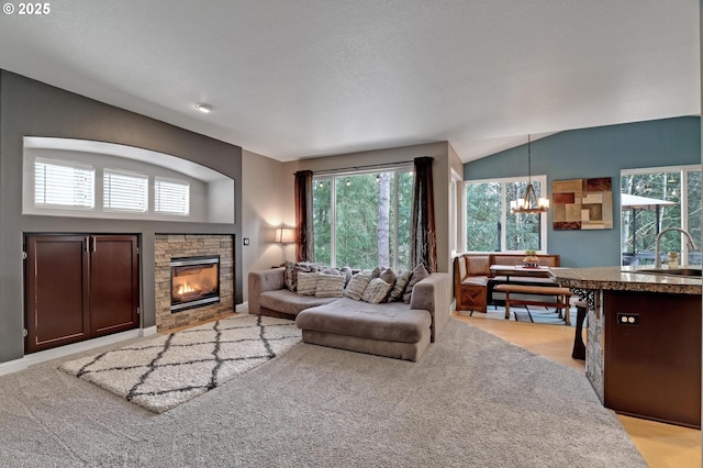 1044 N 26th Ter, Cornelius, OR 97113 - living room with a chandelier, plenty of natural light, a fireplace, and lofted ceiling