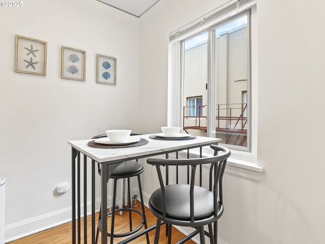 dining area featuring wood finished floors and baseboards