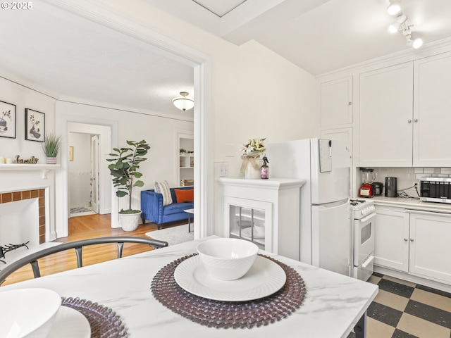 dining space with tile patterned floors and a fireplace