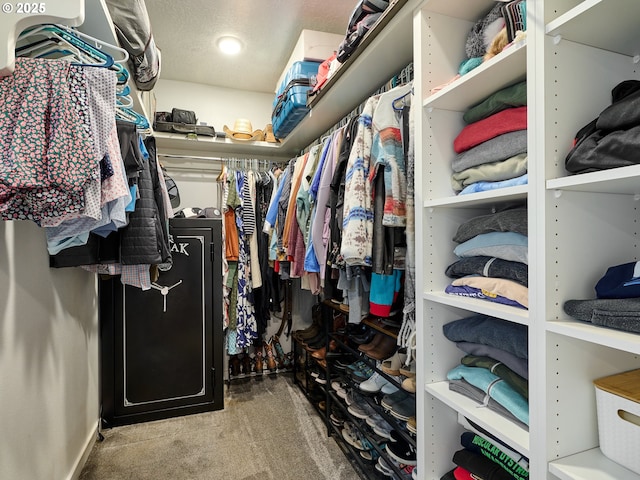 walk in closet featuring light carpet