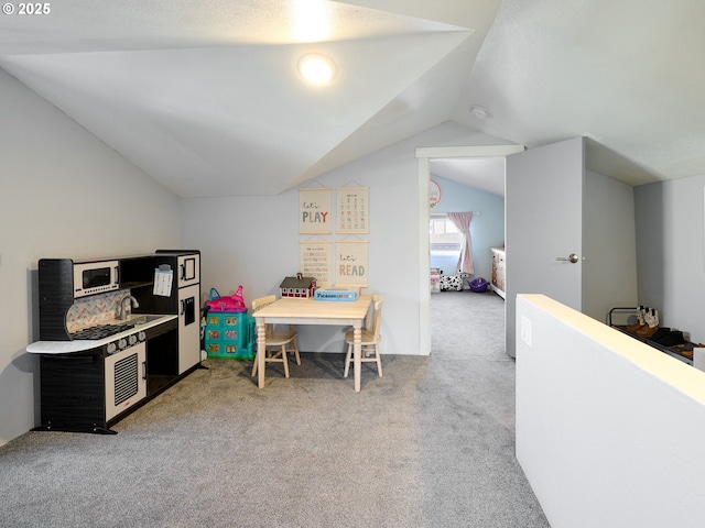 playroom with light colored carpet, lofted ceiling, and sink