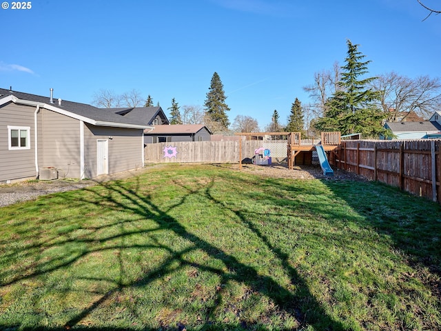 view of yard with cooling unit and a playground