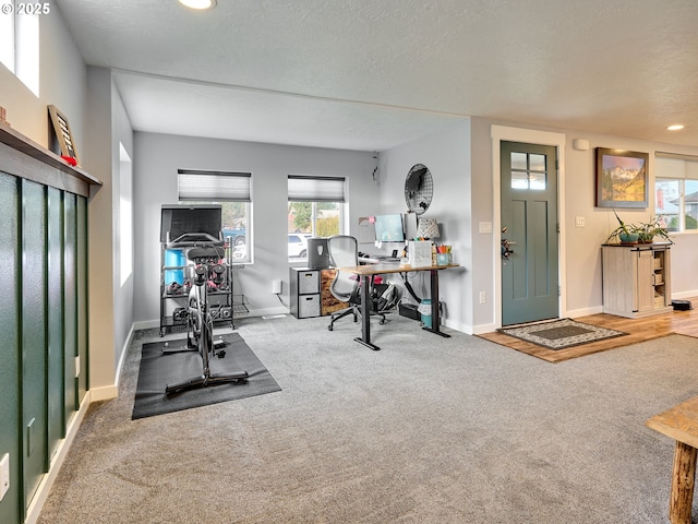 interior space featuring a textured ceiling and carpet