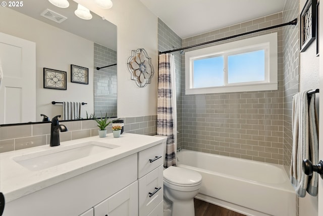 304 SW Birdsdale Dr, Gresham, OR 97080 - bathroom with vanity, shower / bathtub combination with curtain, toilet, wood finished floors, and tile walls