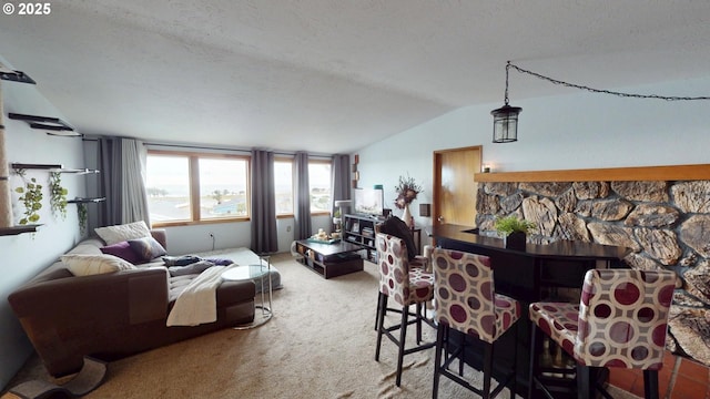 carpeted living room with vaulted ceiling and a textured ceiling