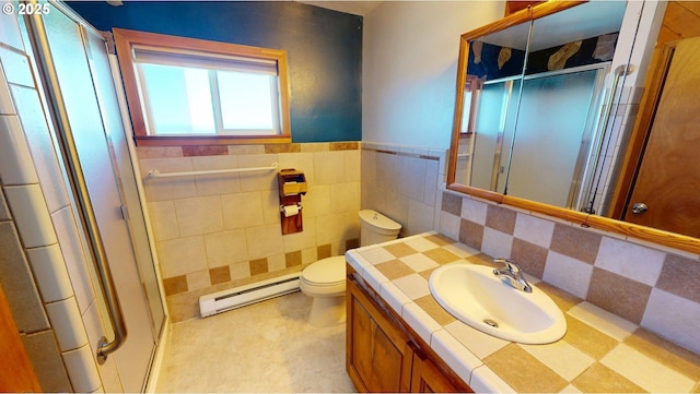 29730 Hillcrest St, Gold Beach, OR 97444 - bathroom with a baseboard heating unit, a stall shower, vanity, toilet, and wainscoting