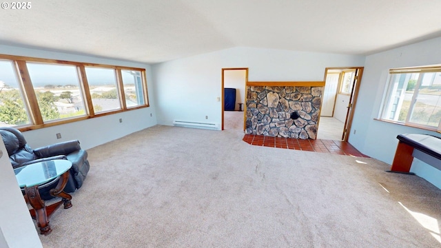 29730 Hillcrest St, Gold Beach, OR 97444 - living area featuring lofted ceiling, a baseboard heating unit, carpet, and a stone fireplace