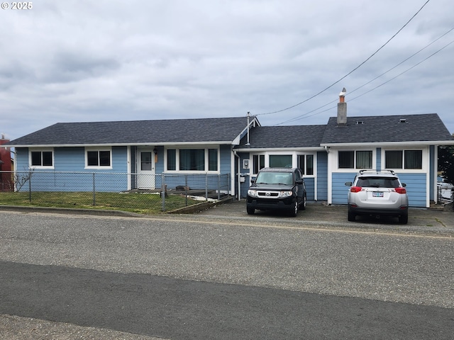 29730 Hillcrest St, Gold Beach, OR 97444 - ranch-style house with a fenced front yard, a chimney, driveway, and roof with shingles