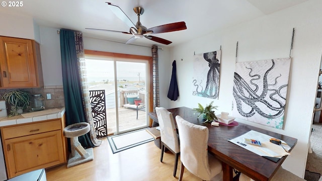 dining room featuring light hardwood / wood-style floors and ceiling fan