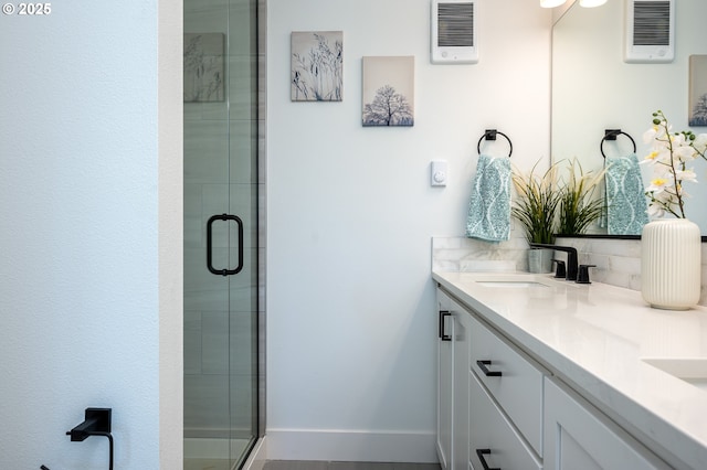 full bath with double vanity, a sink, visible vents, and a stall shower