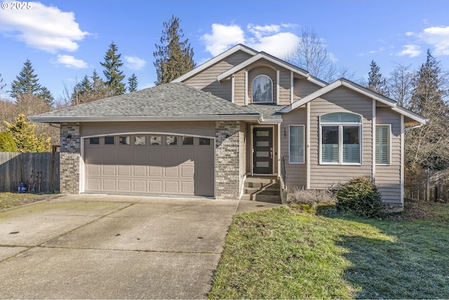 view of front of property featuring a garage and a front lawn