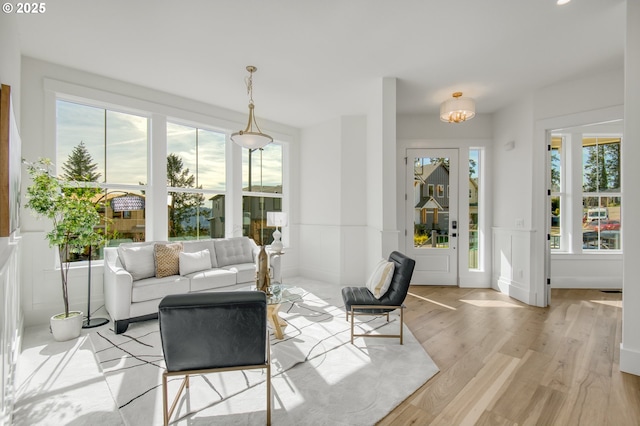 2258 Satter St, West Linn, OR 97068 - living room with light wood finished floors, a decorative wall, and a wainscoted wall