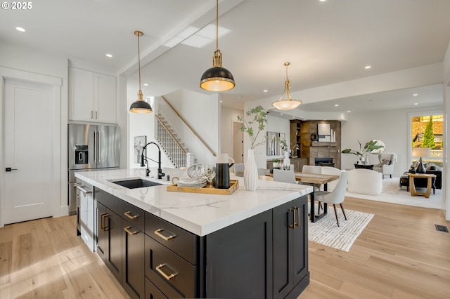 2258 Satter St, West Linn, OR 97068 - kitchen with a sink, light wood-style flooring, high end refrigerator, open floor plan, and white cabinets
