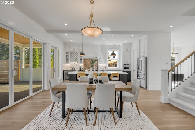 2258 Satter St, West Linn, OR 97068 - dining room with light wood-style flooring, stairway, and recessed lighting