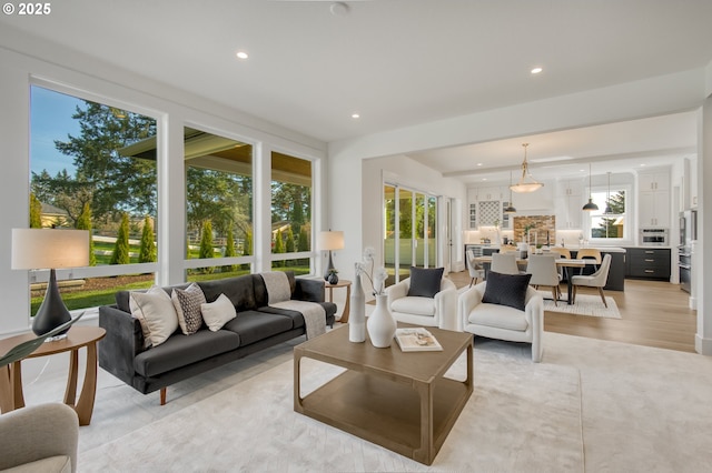 living room with recessed lighting and light wood-style floors
