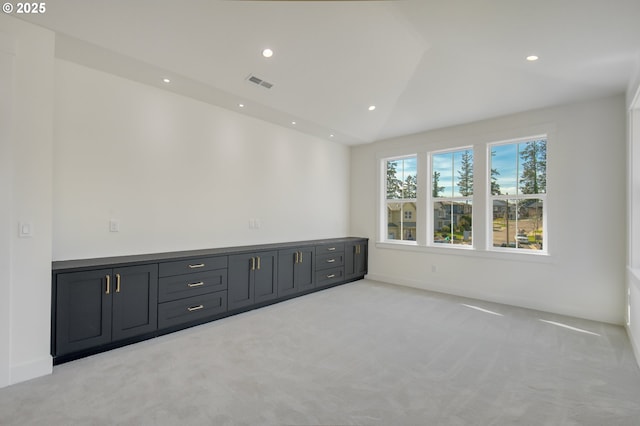spare room with light carpet, recessed lighting, and vaulted ceiling