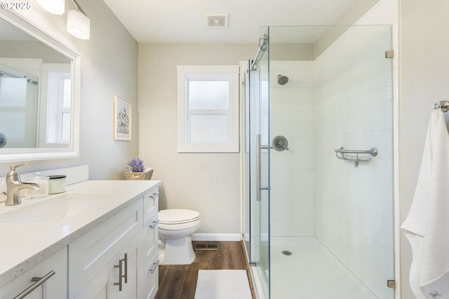 full bath featuring visible vents, a stall shower, and wood finished floors