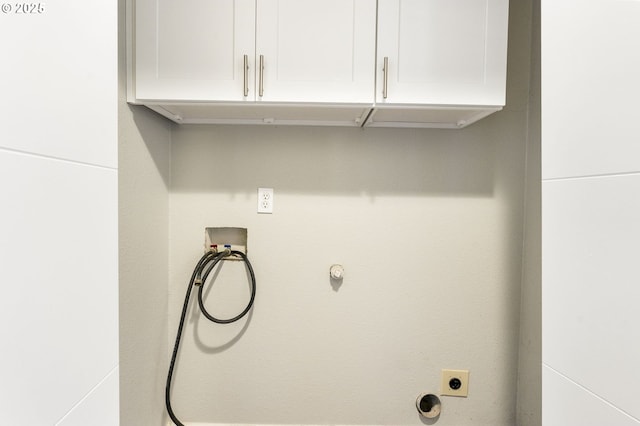 washroom with cabinet space, hookup for a washing machine, electric dryer hookup, and hookup for a gas dryer