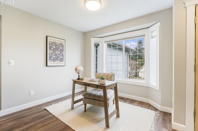 office featuring baseboards and wood finished floors