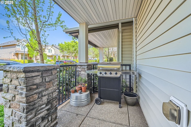 view of patio / terrace with covered porch, a residential view, and grilling area