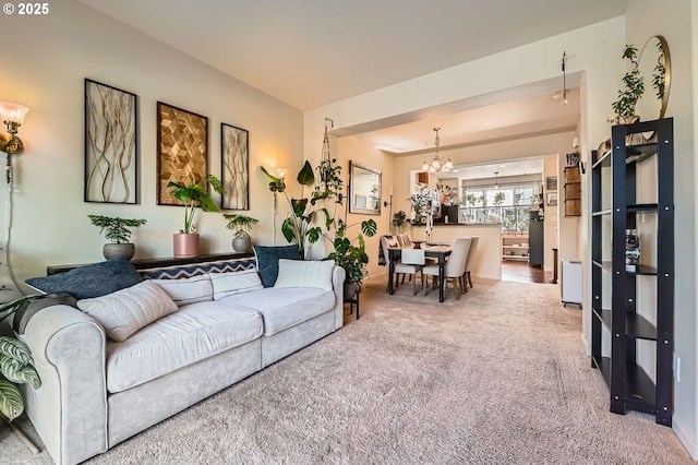 living room featuring carpet floors and a notable chandelier