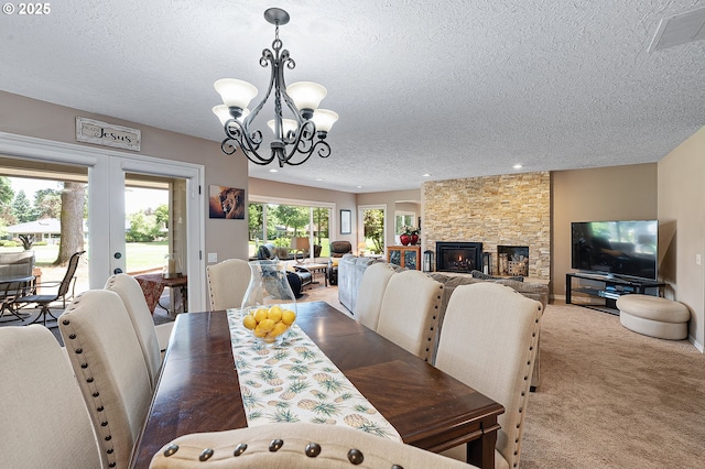 7250 SW Arbor Lake Dr, Wilsonville, OR 97070 - carpeted dining room with a textured ceiling, french doors, a chandelier, a fireplace, and recessed lighting