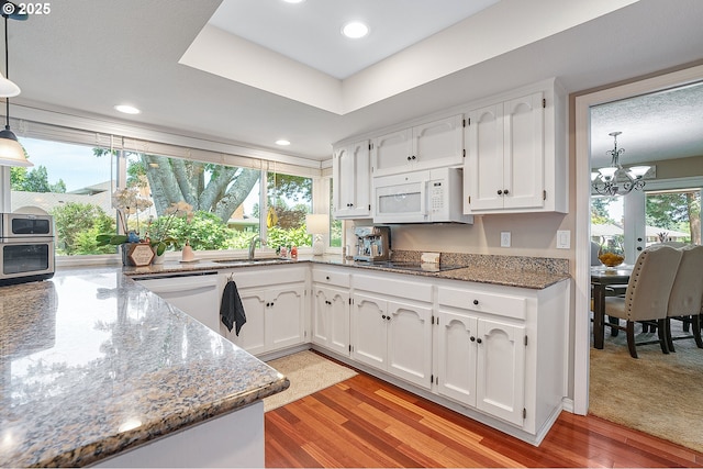 7250 SW Arbor Lake Dr, Wilsonville, OR 97070 - kitchen featuring white appliances, a sink, a chandelier, white cabinets, and recessed lighting