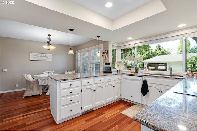 7250 SW Arbor Lake Dr, Wilsonville, OR 97070 - kitchen with dishwasher, light wood-type flooring, a peninsula, white cabinets, and a sink