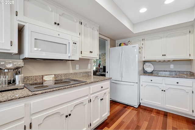 7250 SW Arbor Lake Dr, Wilsonville, OR 97070 - kitchen featuring white appliances, wood finished floors, white cabinetry, recessed lighting, and light stone countertops