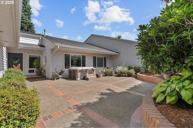 7250 SW Arbor Lake Dr, Wilsonville, OR 97070 - rear view of property featuring a patio area, a hot tub, and a shingled roof