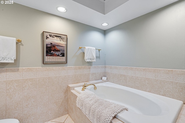 7250 SW Arbor Lake Dr, Wilsonville, OR 97070 - bathroom featuring a bath, recessed lighting, toilet, tile patterned floors, and tile walls