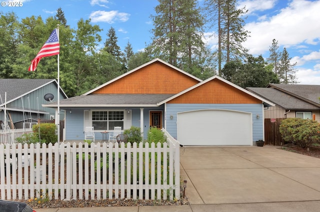 25246 Corky Ln, Veneta, OR 97487 - view of front of property with a porch, an attached garage, concrete driveway, and a fenced front yard
