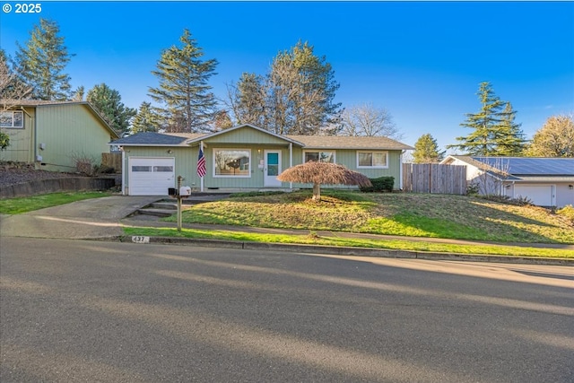 ranch-style home featuring a garage and a front yard