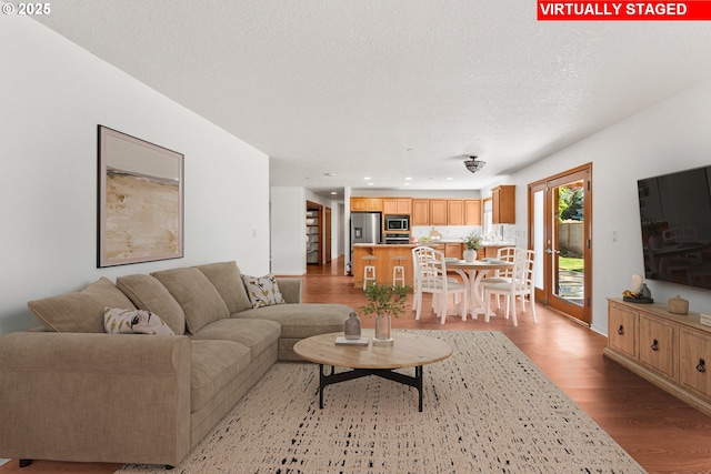 living room featuring light wood finished floors and recessed lighting