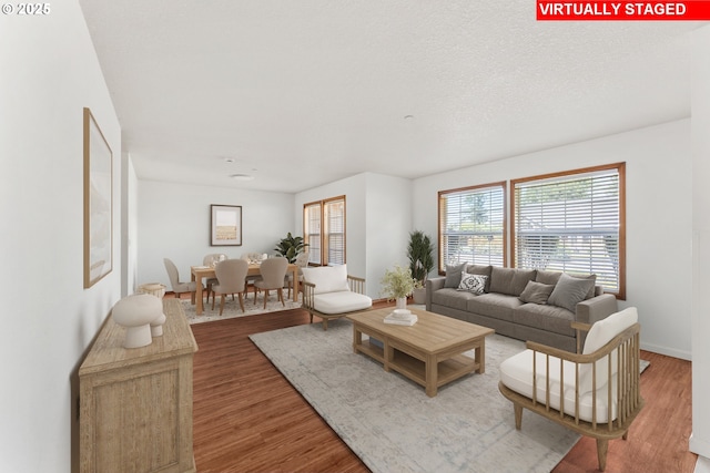 living area featuring wood finished floors and baseboards