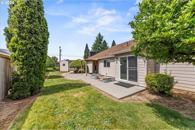 view of yard featuring a patio and an outdoor structure