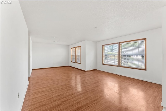 unfurnished room featuring light wood-style flooring and baseboards