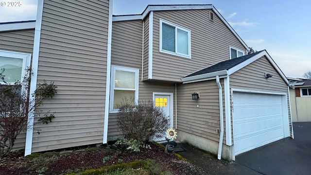 view of home's exterior featuring aphalt driveway and an attached garage