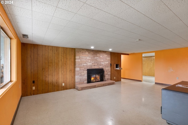 1520 Main St, Forest Grove, OR 97116 - unfurnished living room with tile patterned floors, wood walls, and a fireplace