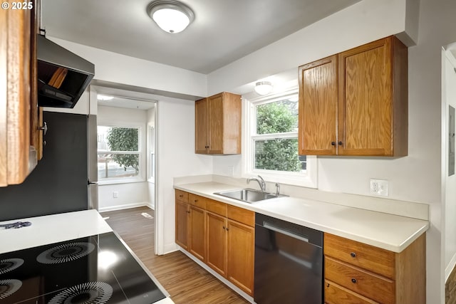 11355 SW 97th Ct, Portland, OR 97223 - kitchen with dishwashing machine, ventilation hood, wood finished floors, freestanding refrigerator, and light countertops