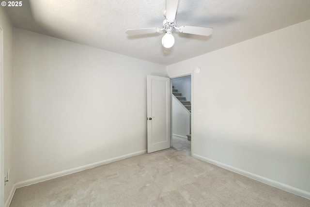 11355 SW 97th Ct, Portland, OR 97223 - spare room featuring light carpet, a ceiling fan, and a textured ceiling