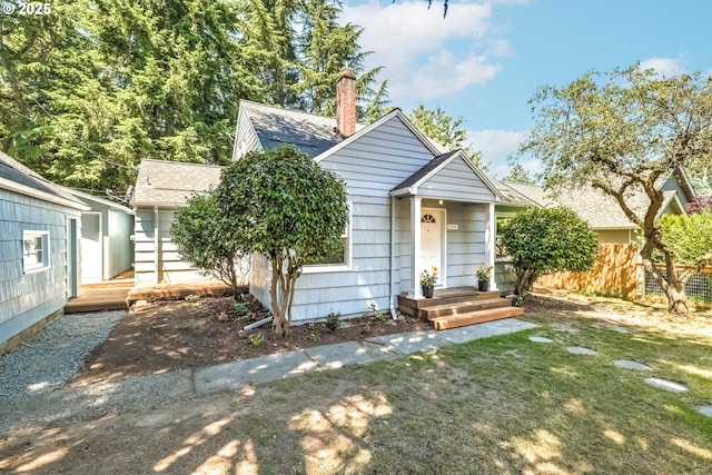 11355 SW 97th Ct, Portland, OR 97223 - bungalow-style home featuring a shingled roof, a front yard, and a chimney