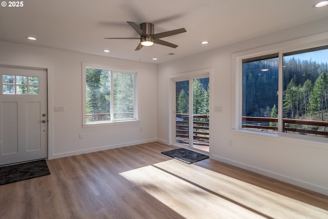 foyer entrance featuring visible vents, baseboards, wood finished floors, and recessed lighting